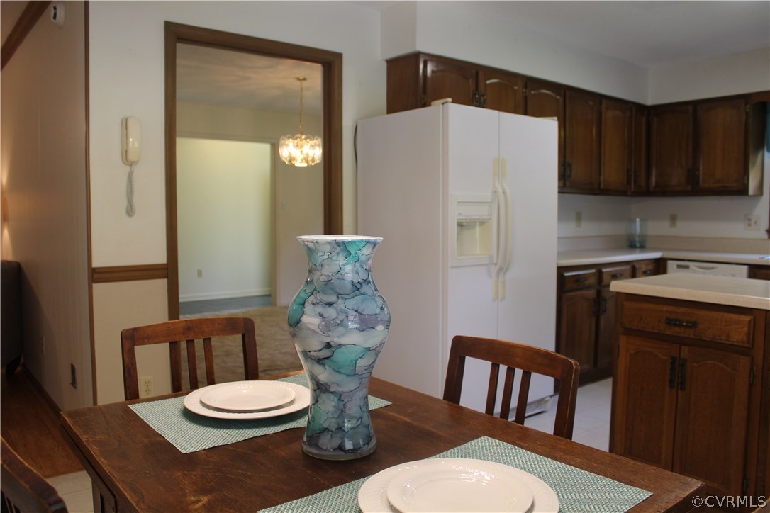 20600 Rowanty Road Carson, VA 23830 - Photo 10 of 25 a kitchen with a table chairs and a refrigerator