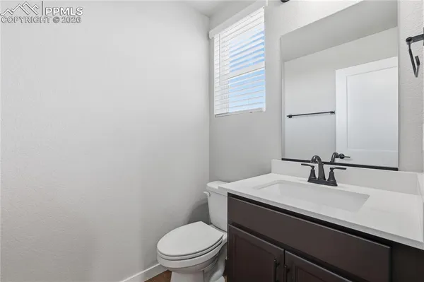 a bathroom with a sink a toilet and mirror