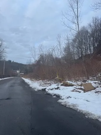 a view of a dirt road near a building