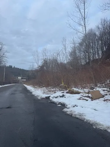 a view of a dirt road near a building