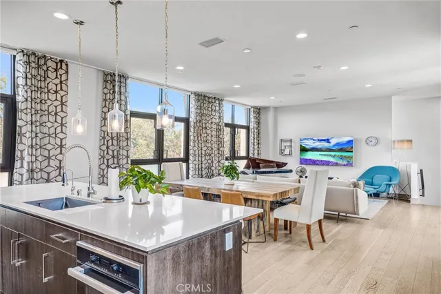 a kitchen with stainless steel appliances granite countertop a sink a stove and a refrigerator