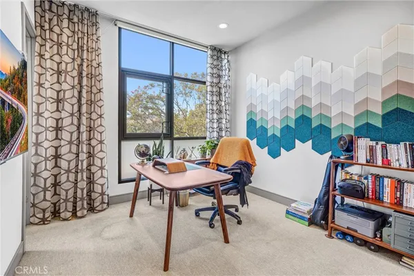 a spacious bedroom with a bed and a dresser in it