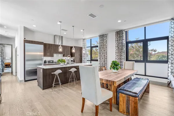 a kitchen with a table chairs refrigerator and microwave