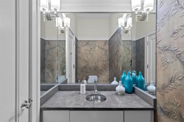 a bedroom with a bed and a lamp on dresser