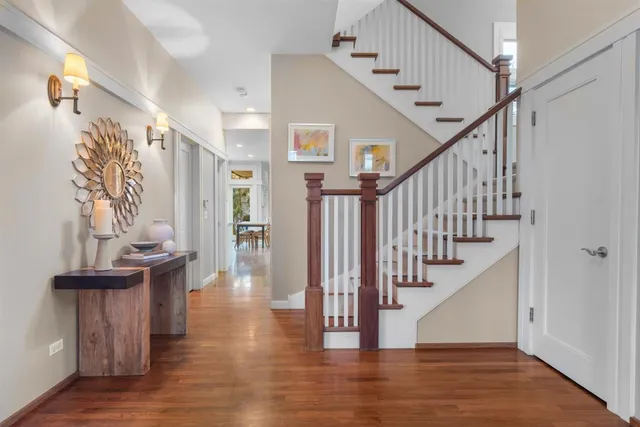 a living room with fireplace furniture and two large window