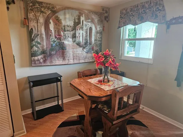 a view of a dining room with furniture and window