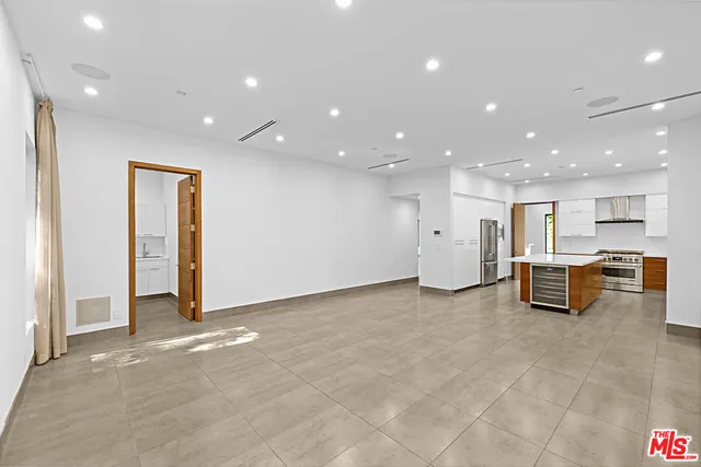 a view of a kitchen with a sink stove and cabinets