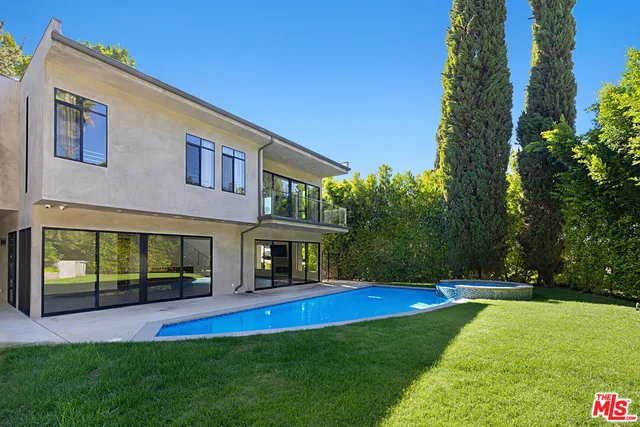 a view of a house with swimming pool and porch