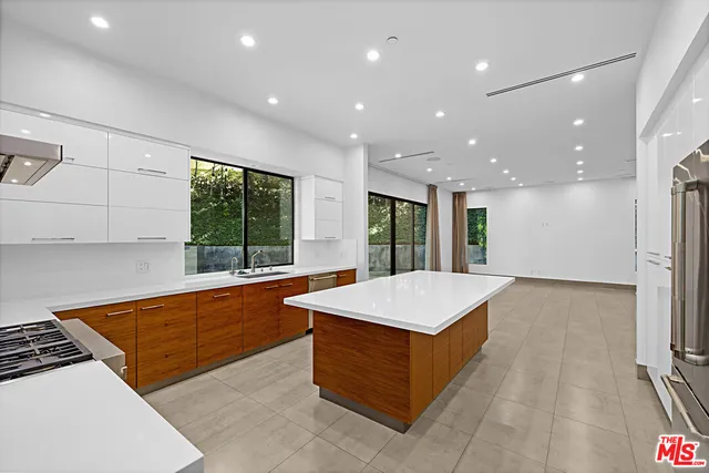 a room with pool table and windows