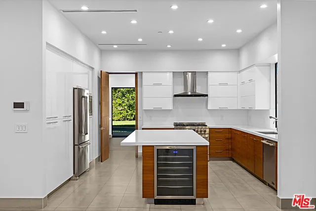 a kitchen with stainless steel appliances granite countertop a refrigerator and a sink