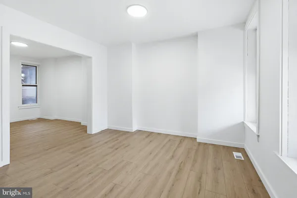 a view of an empty room and wooden floor