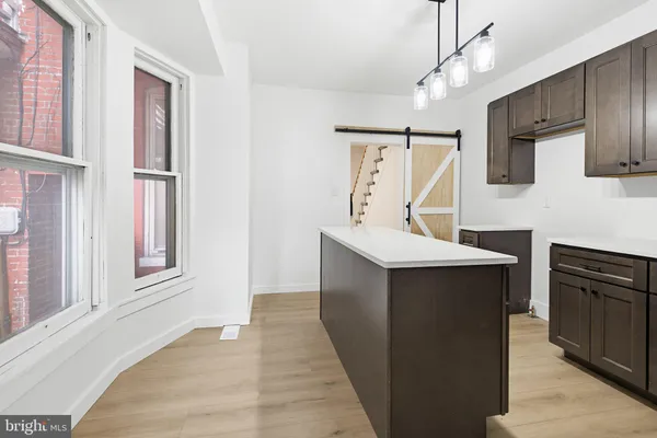 a kitchen with wooden cabinets and stainless steel appliances