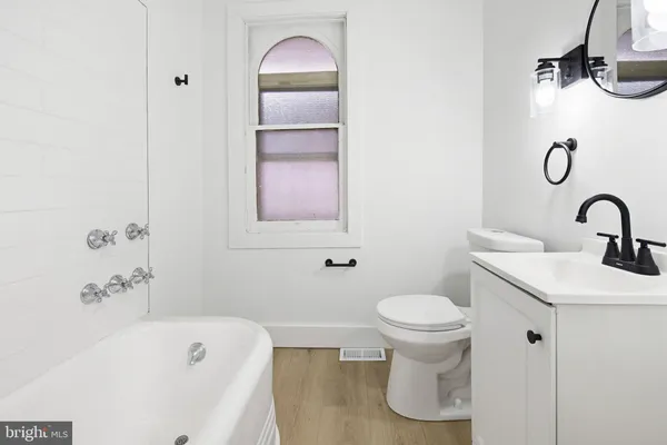 a bathroom with a sink a toilet and a bathtub