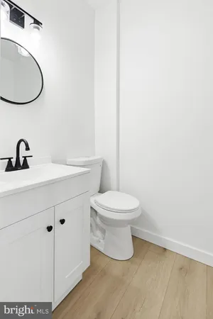 a bathroom with a toilet a sink and mirror