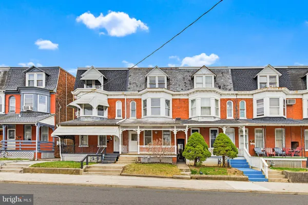 a front view of a residential apartment building with a yard