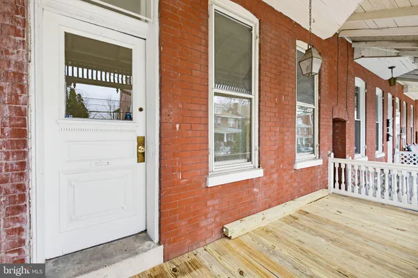 a view of a brick house with many windows