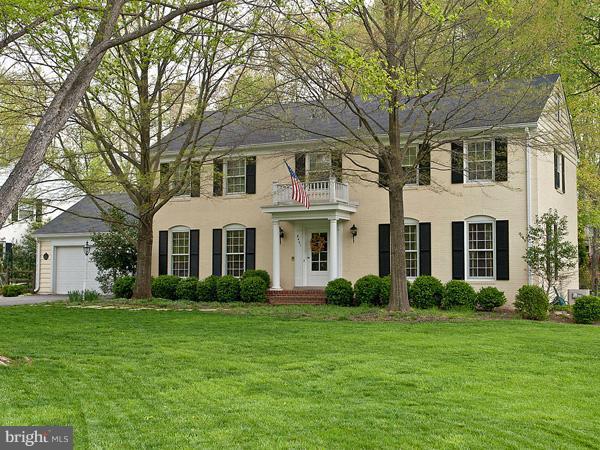 8401 Kingsgate Road Potomac, MD 20854 - Photo 1 of 1 a front view of a house with garden and trees