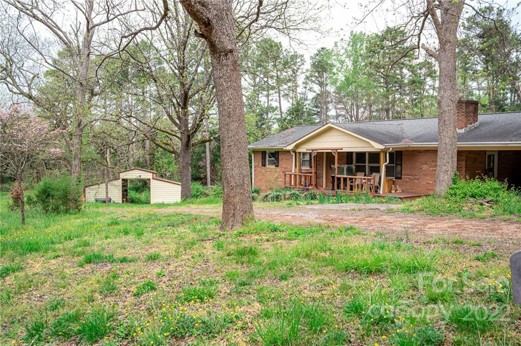 a front view of a house with a yard and trees