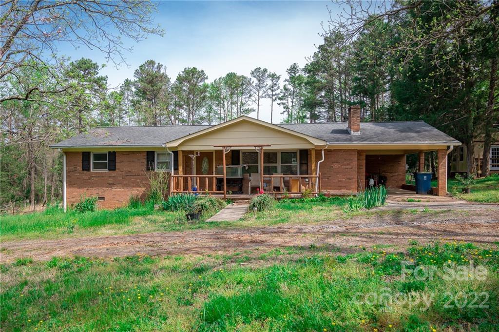 9201 Phelps Road Mount Pleasant, NC 28124 - Photo 2 of 24 a front view of a house with garden