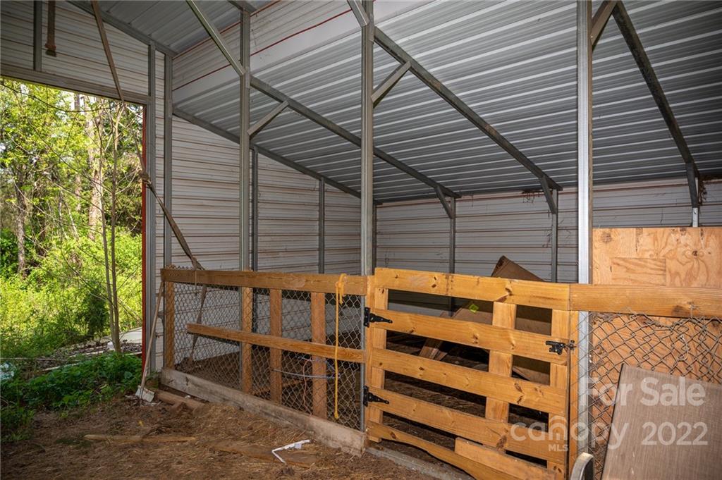 9201 Phelps Road Mount Pleasant, NC 28124 - Photo 21 of 24 a backyard of a house with large trees and stairs