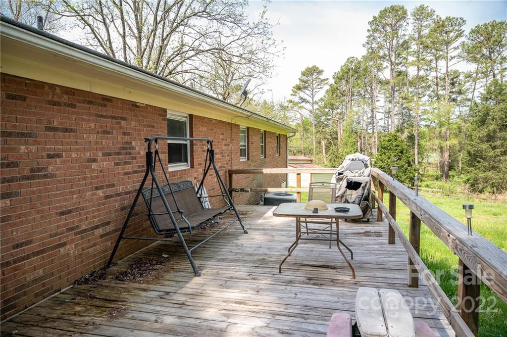 9201 Phelps Road Mount Pleasant, NC 28124 - Photo 9 of 24 a view of a patio with a table and chairs