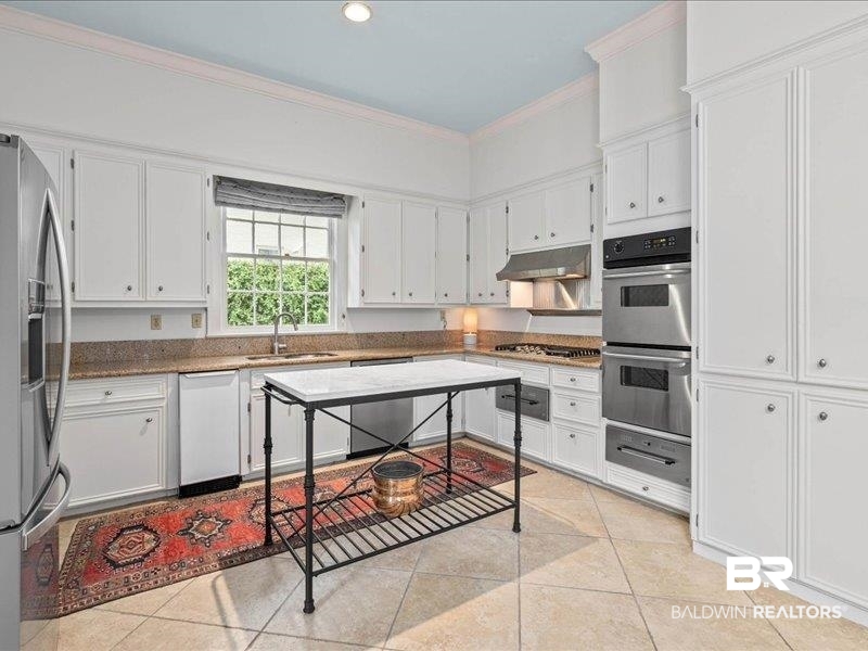 109 Eaton Square Mobile, AL 36608 - Photo 8 of 26 Expansive kitchen featuring white cabinetry, granite countertops, and stainless steel appliances including a built-in double oven and gas cooktop