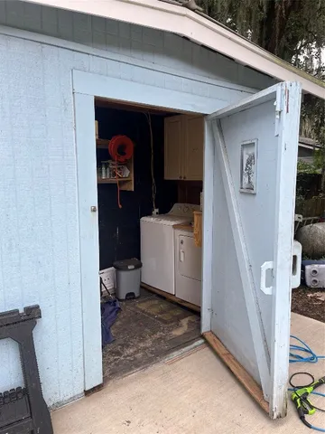 a utility room with a sink and washing machine