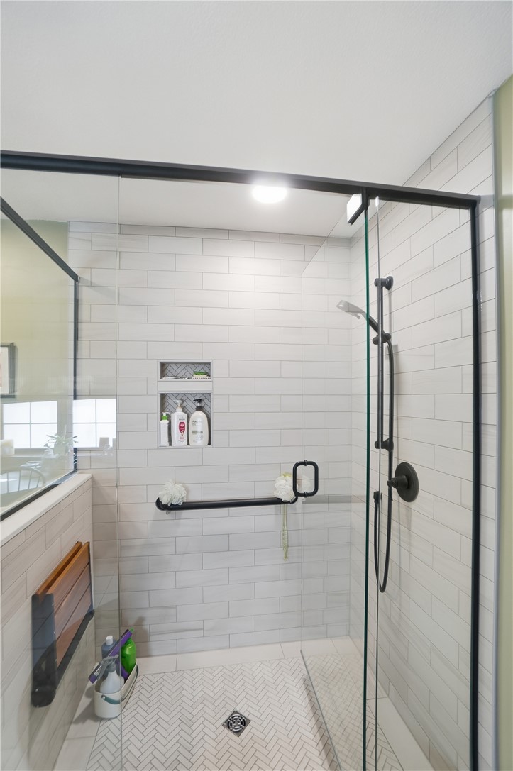 5300 Brookshire Lane Springfield, OH 45502 - Photo 33 of 56 This sleek shower space offers contemporary tiling and practical, accessible features.