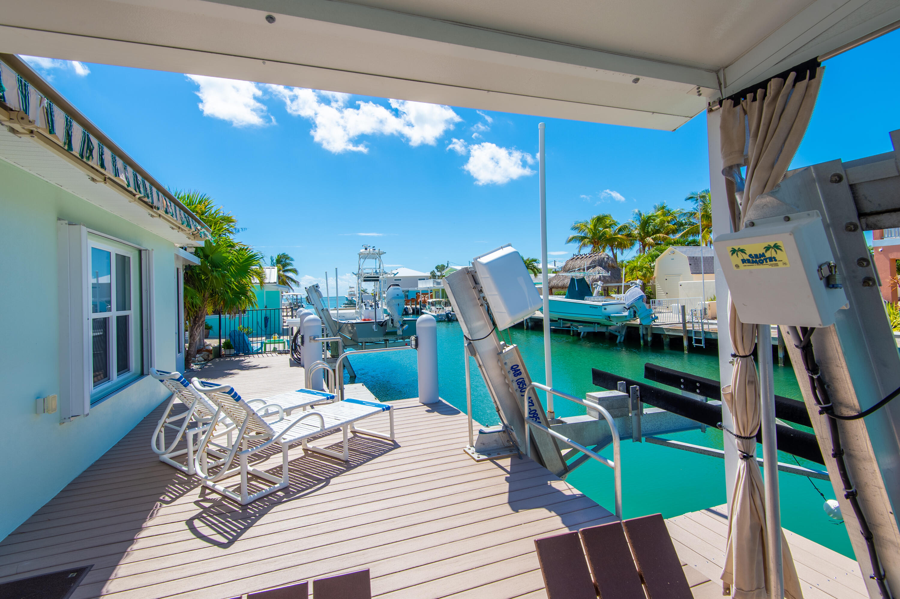 11322 3rd Avenue Marathon, FL 33050 - Photo 8 of 39 a view of a dining room with furniture a chandelier and wooden floor