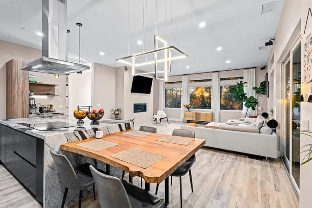 a bedroom with a bed and a dresser with wooden floor