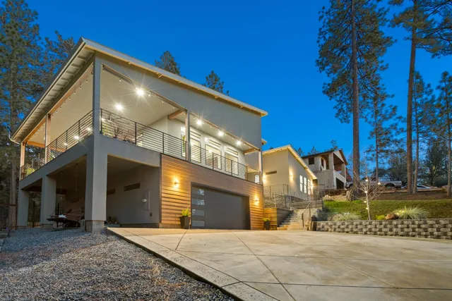 a view of a house with backyard and sitting area