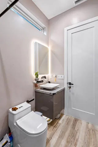 a bathroom with a sink a toilet and mirror
