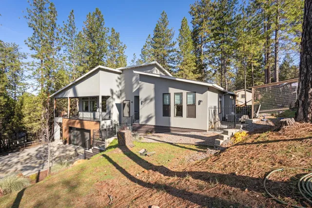 a living room with stainless steel appliances kitchen island granite countertop a stove and a large countertops with wooden floor