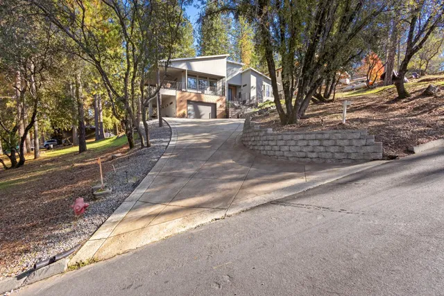 a living room with furniture kitchen view and a large window