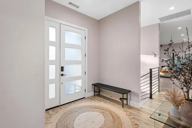 a bedroom with bed and a chandelier