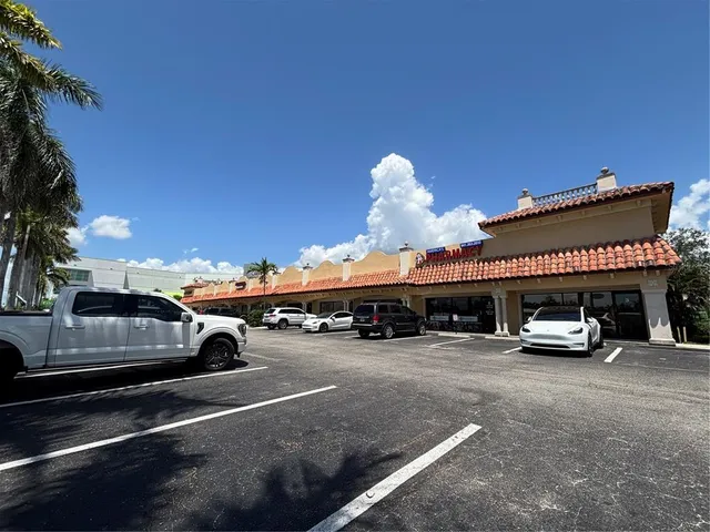 a view of a cars park in front of a building