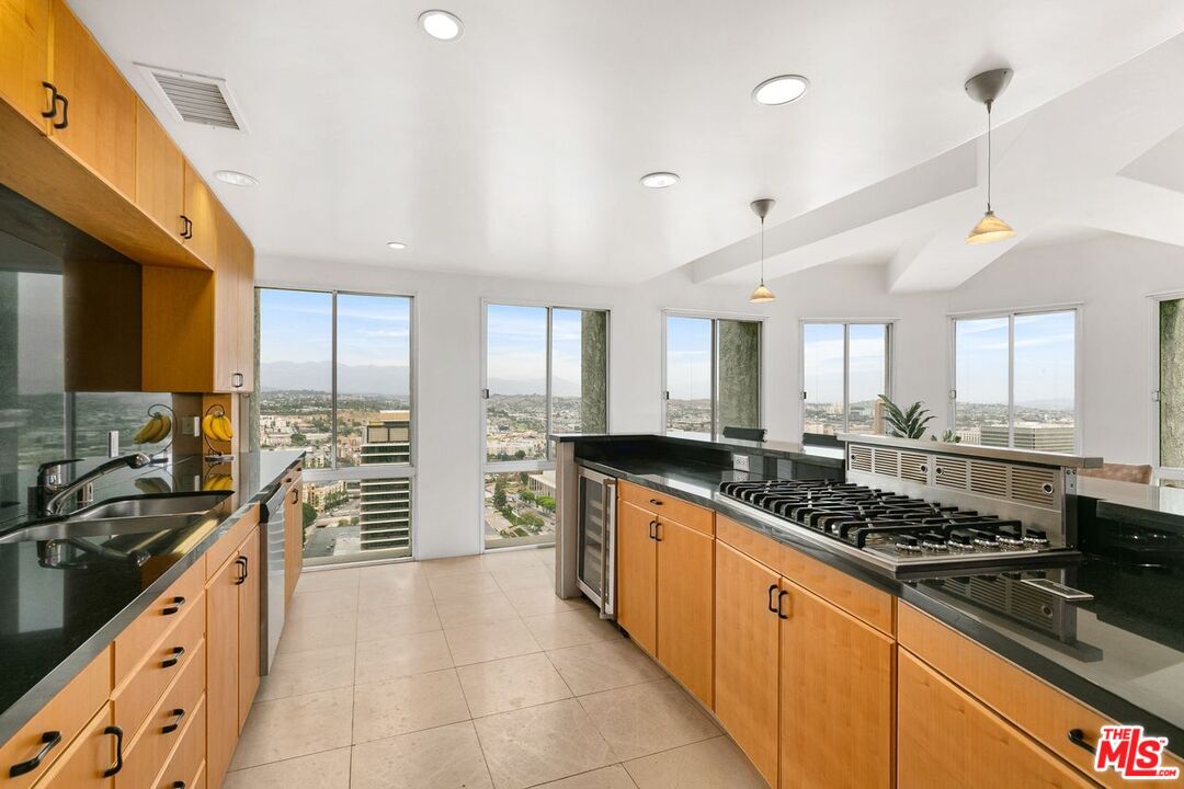 800 West 1st Street, Unit 3102 Los Angeles, CA 90012 - Photo 1 of 52 a large kitchen with stainless steel appliances a stove a sink a counter space and cabinets