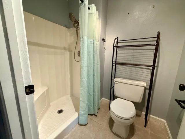 a bathroom with a toilet and shower