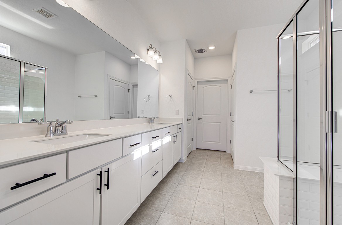 169 Slenderleaf Drive Marble Falls, TX 78654 - Photo 16 of 24 a large white bathroom with a double vanity sink a mirror and a shower