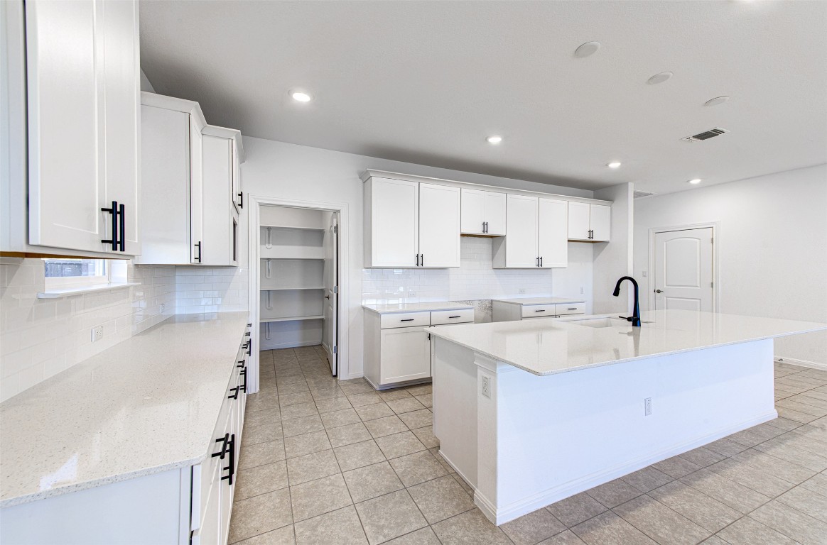 169 Slenderleaf Drive Marble Falls, TX 78654 - Photo 6 of 24 a large kitchen with stainless steel appliances granite countertop a sink and cabinets