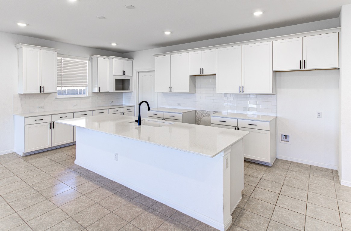 169 Slenderleaf Drive Marble Falls, TX 78654 - Photo 7 of 24 a kitchen with a sink a stove and cabinets
