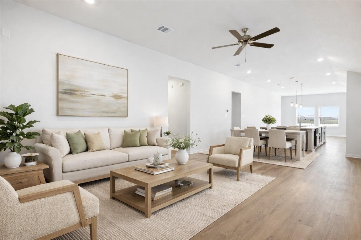 a living room with furniture and a view of kitchen