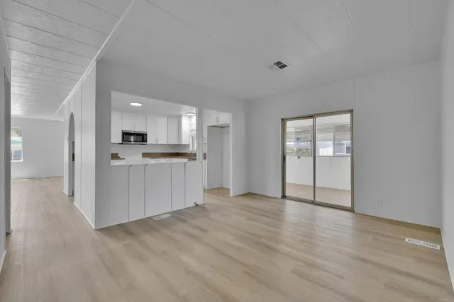 a view of empty room with large windows