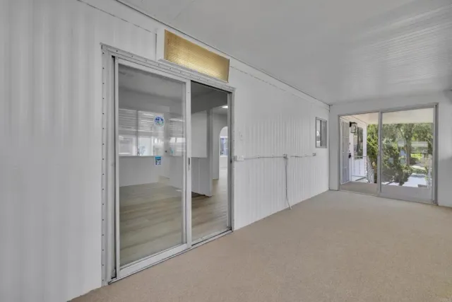a view of an empty room and wooden floor