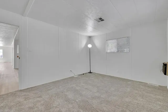 a bedroom with a bed and a night stand