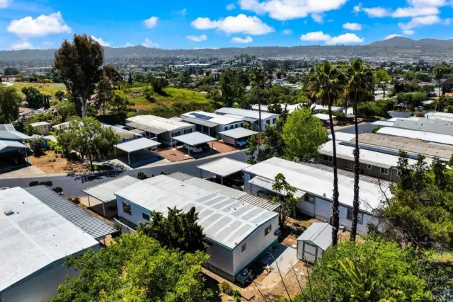 a view of a street with a house in the background