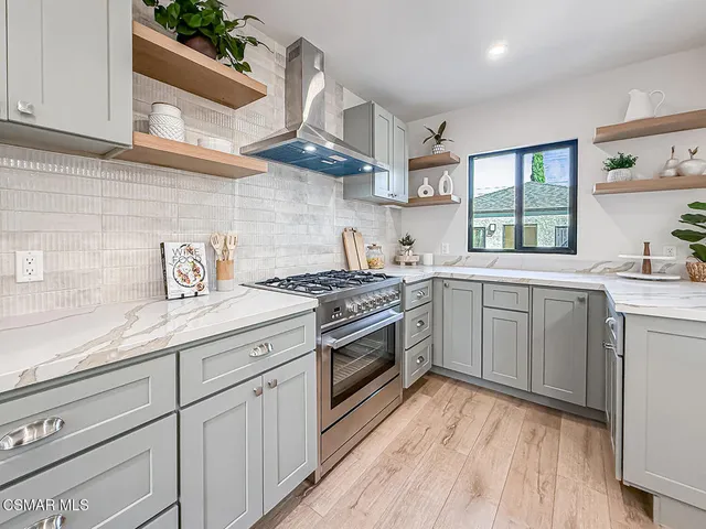 a kitchen that has a sink and a stove in it