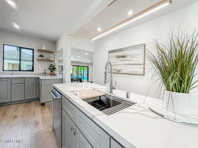 a living room with furniture and kitchen view