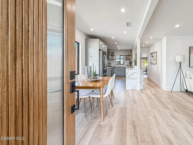 a dining room with furniture and wooden floor