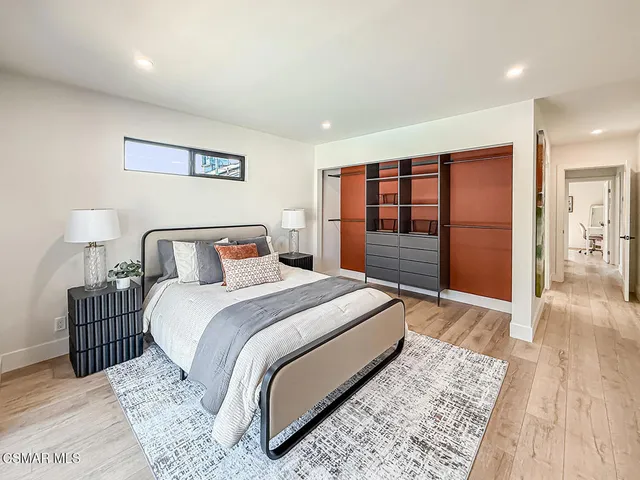 a view of a hallway view with living room and wooden floor